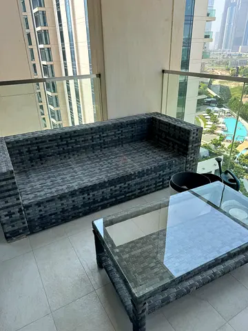 Outdoor rattan 2-seater sofa plus 2 chairs with glass-top coffee table - good condition.