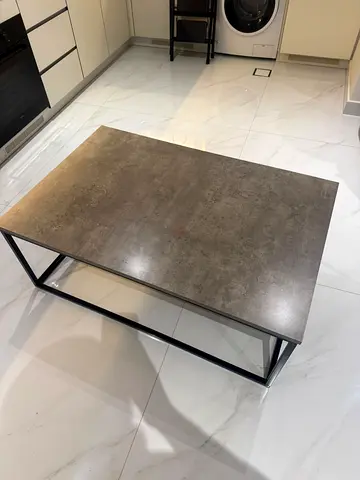 Modern rectangular coffee table with polished concrete effect top and matte black metal frame