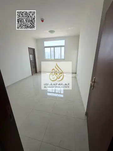 Two-bedroom apartment with a living room on the Ajman Corniche; annual rent, first-time occupancy, includes private parking within the tower.
