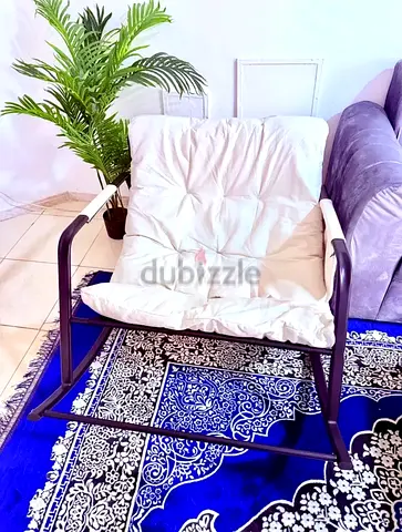 Single cushioned lounge chair with metal frame