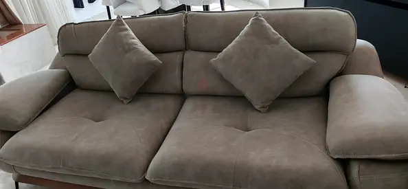 Comfortable Grey Fabric Sofa with Two Throw Pillows