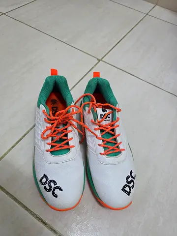 White DSC sports shoes with green lining and orange laces - size available
