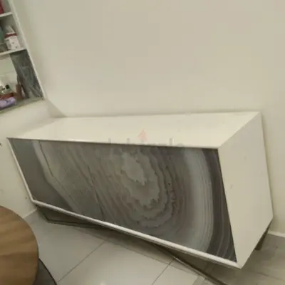 White wall-mounted console cabinet with decorative front panel