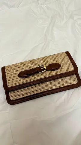 Brown woven clutch wallet with buckle detail