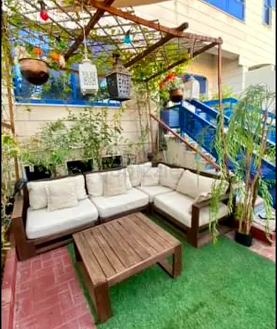 Outdoor wooden L-shaped sofa set with coffee table and cushions