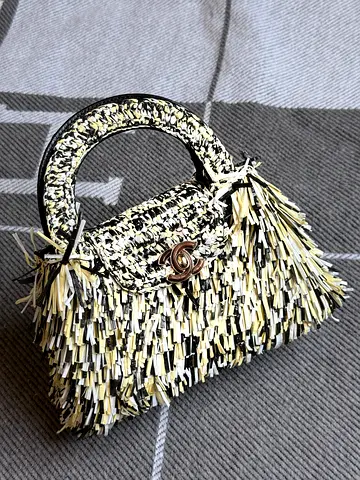 Small fringed top-handle designer-style handbag with CC turn-lock