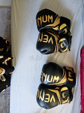 Two pairs of Venum boxing gloves - black/gold, good condition