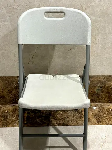 White plastic folding chair with metal frame - good condition