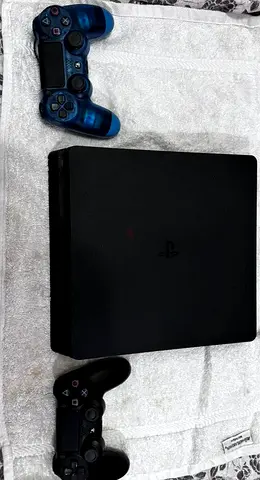 PlayStation 4 Slim console with 2 DualShock controllers - good working condition