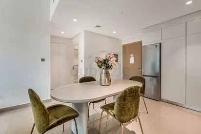 Modern oval dining table with 4 green velvet chairs