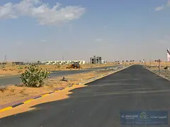Residential/commercial land for sale in Al Amrah area, on a street and alley. The plot measures 20,6