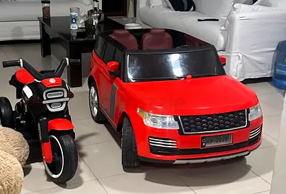 Red electric ride-on car (2-seater) with matching kids ride-on motorbike