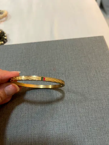 Set of two gold-tone bangles, one textured and one plain