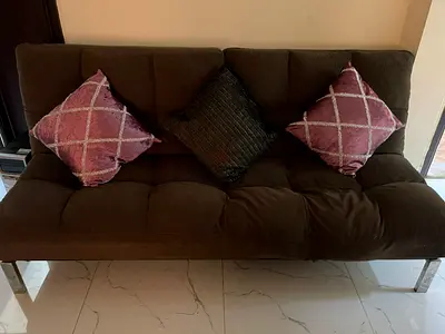 Convertible couch in alain good condition dark brown colour metal legs (pillows not included)