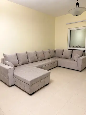 Light grey U-shaped sectional sofa bed with storage excellent condition