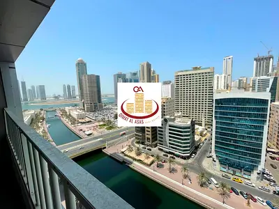 Three bedrooms and a living room with a view of Al Qasba and Al Majaz Lake + parking space + 2 balc