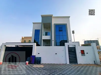 Villa for sale in Al Helio, Ajman, featuring 4 master bedrooms, a majlis, a living area, and a maid
