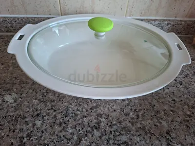 Oval ceramic covered serving dish with glass lid (used) and have stand and burner also