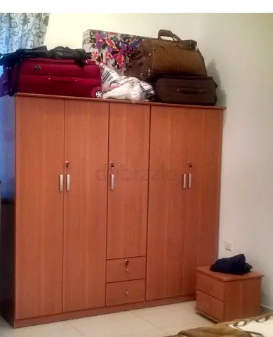 Four-door wooden wardrobe with two drawers excluding side table