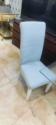 Light grey upholstered dining chair with wooden legs - single piece