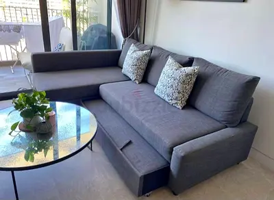 Gray L-shaped Sofa with Pull-out Bed and Storage - Good Condition