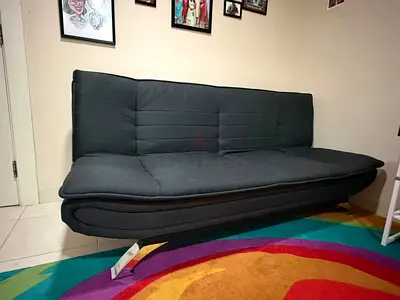 Dark grey convertible sofa bed in good condition
