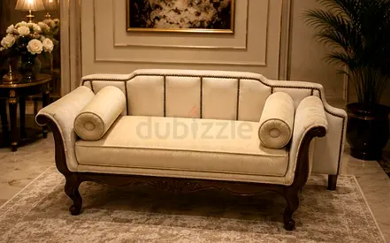 Antique-style carved wooden loveseat with cream upholstery