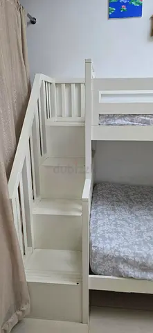 White wooden bunk bed with built-in storage stairs - good condition