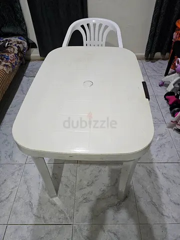 White Plastic Outdoor Dining Table and one plastic chair