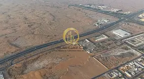 An industrial land in the Al Bataih area with a prime location, entrance from Al Dhaid Road and Khor