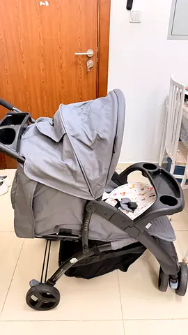 Light grey baby stroller with cup holders and large canopy - good condition