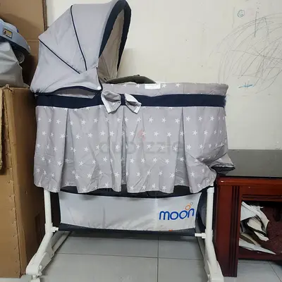 Used Moon baby bassinet with canopy and storage - gray star print