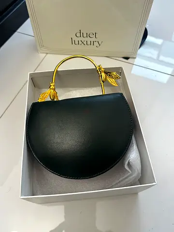 Small black leather handbag with gold leaf handle - unused from duet luxury