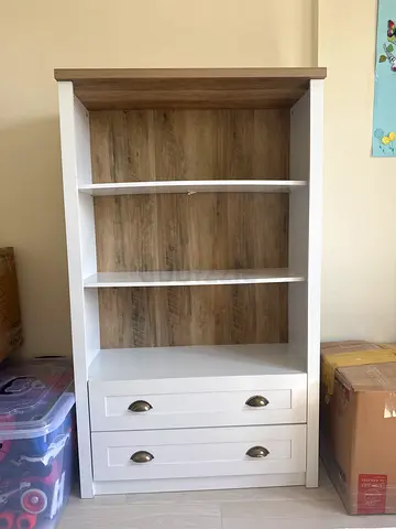 White wooden shelving unit with 3 open shelves and 2 drawers