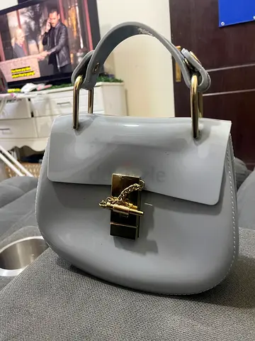 Grey patent mini top-handle handbag with gold clasp
