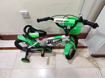 Kids green and white 12-inch bicycle with training wheels and basket