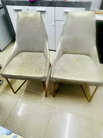 Pair of modern upholstered dining chairs with gold legs