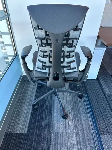 Herman Miller Embody ergonomic office chair featuring gray fabric and adjustable black Armrests