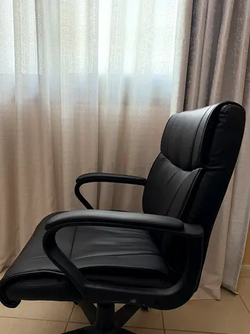 Black leather swivel office chair with armrests and high back