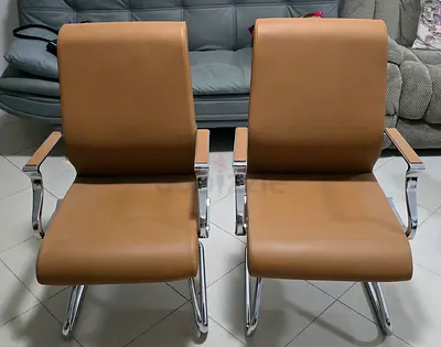 Pair of brown leather visitor chairs with chrome frame