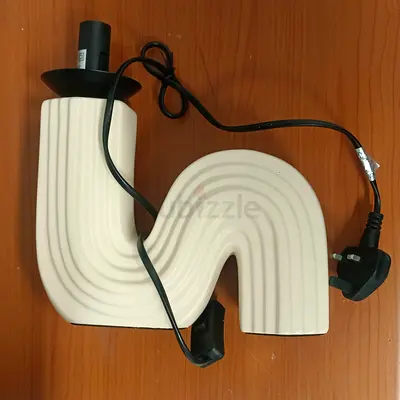 Used white decorative table lamp with curved S-shape base (works)