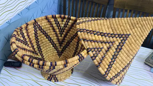 Handwoven decorative basket with conical lid