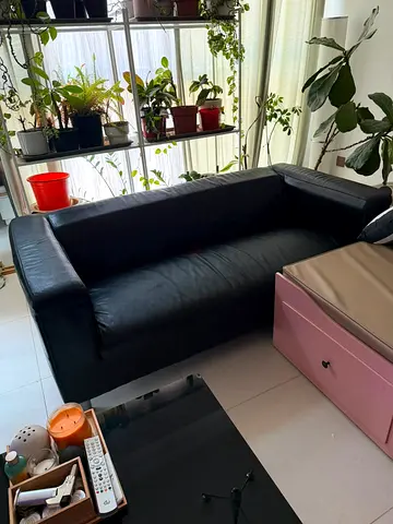 Used IKEA black leather 2-seater sofa in good condition