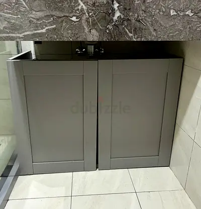 IKEA Gray bathroom vanity cabinet with double doors — compact under-sink storage