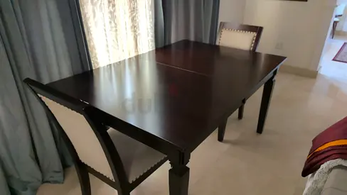 Dark wood extendable dining table with 4 upholstered chairs