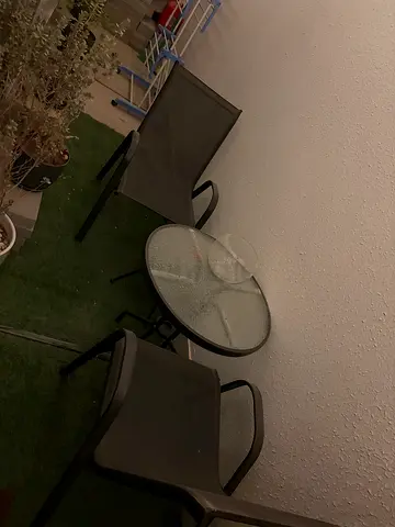 Small outdoor bistro set – glass table with two mesh chairs