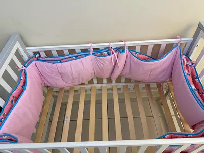 White Baby Crib with Pink Bumper - Good Condition