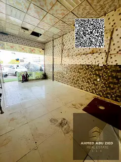 Commercial shop for annual rent in Al Rawda 2, prime location near all services, on a main road near