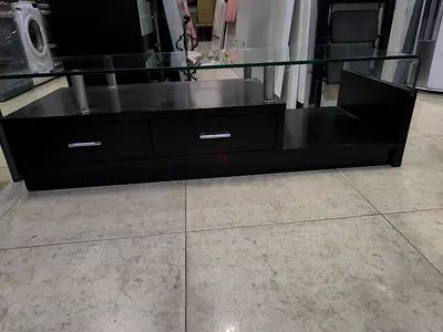 Dark wood TV entertainment unit with glass top and drawers