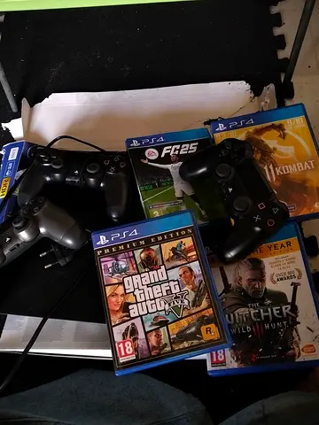 PlayStation 4 console with controllers and 4 games